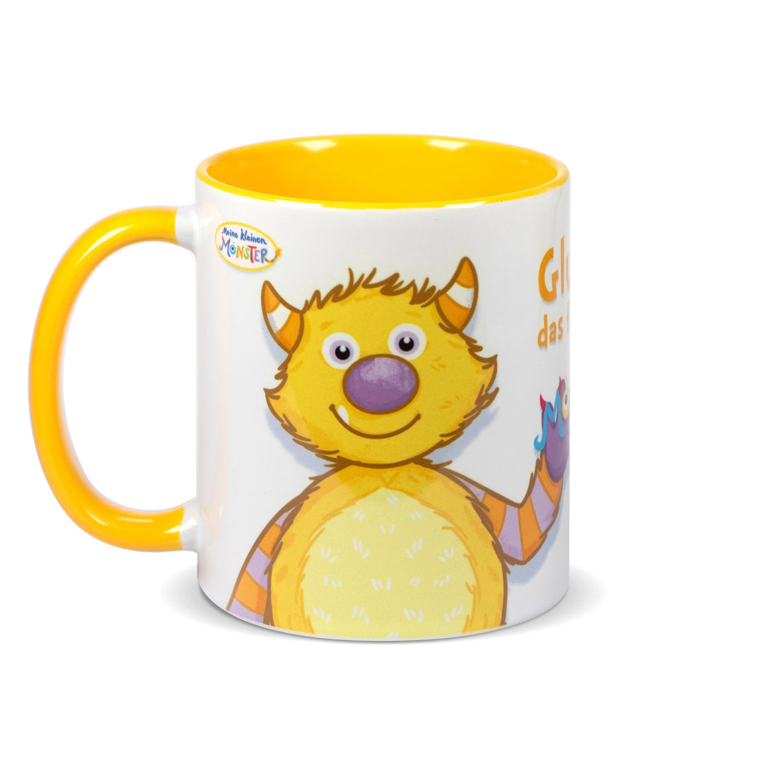 Keramiktasse mit gelbem Henkel und gelbem Innenrand, bedruckt mit dem fröhlichen Monster „Glucksi“ in Gelb und Lila.