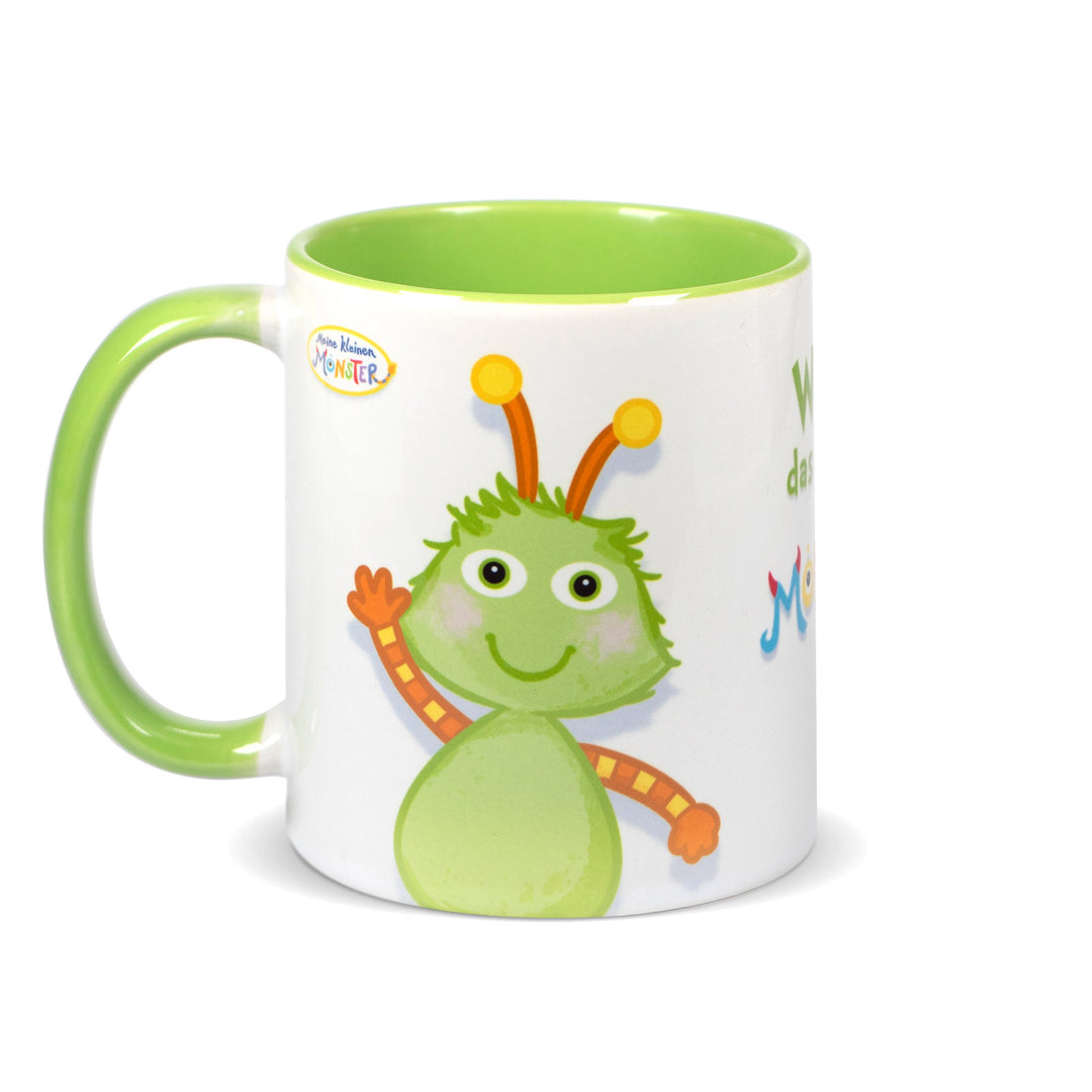 Keramiktasse mit hellgrünem Henkel und hellgrünem Innenrand, bedruckt mit dem kleinen grünen Monster „Winz“ mit Fühlern.