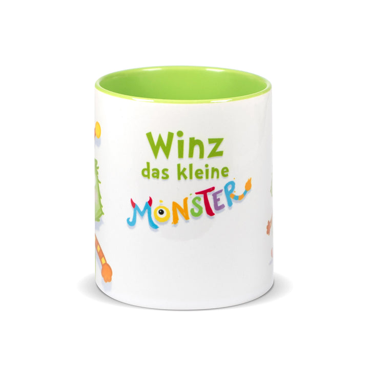 Weiße Keramiktasse mit hellgrünem Innenrand und der Aufschrift „Winz das kleine Monster“ in bunter, verspielter Schrift.